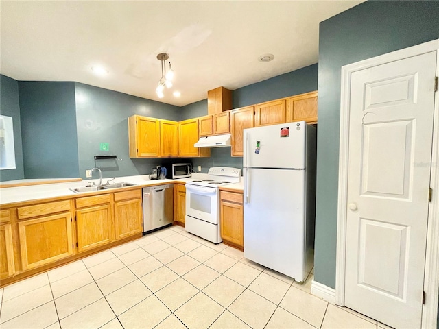 kitchen featuring light tile patterned flooring, sink, stainless steel appliances, and decorative light fixtures