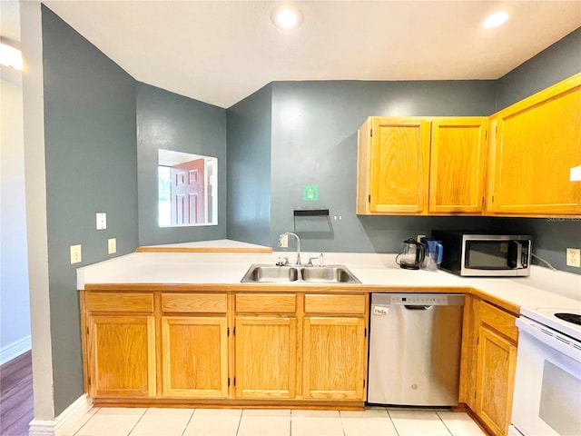 kitchen featuring light tile patterned flooring, sink, and stainless steel appliances