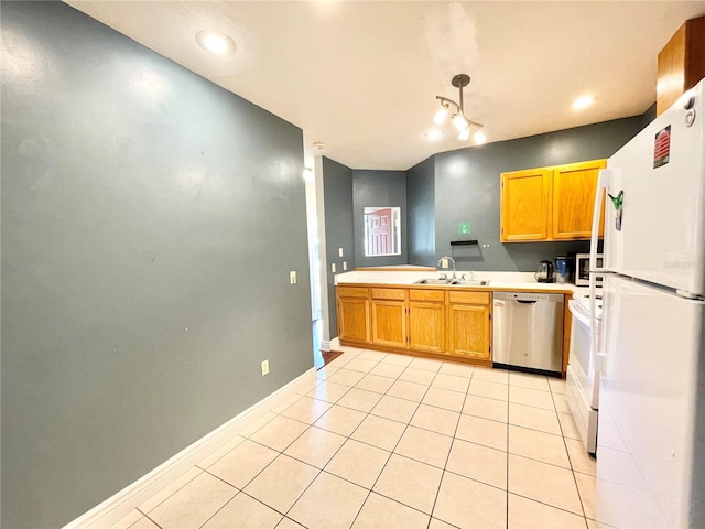 kitchen featuring light tile patterned flooring, decorative light fixtures, sink, and white appliances