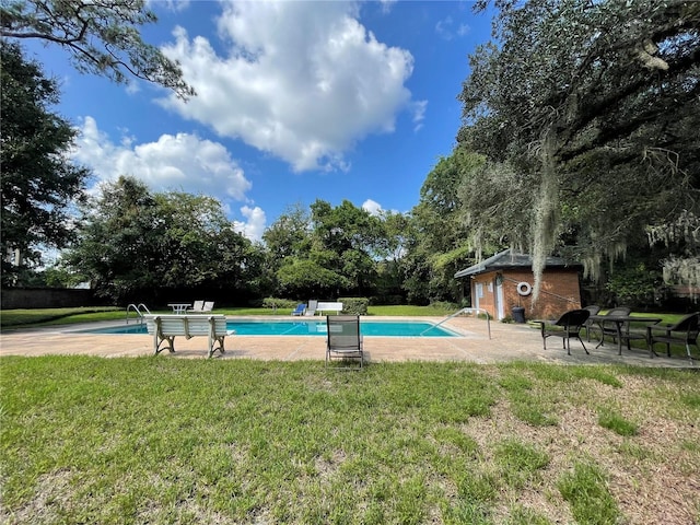 view of pool featuring a patio and a yard