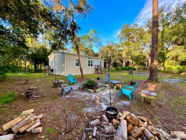 view of yard with a fire pit