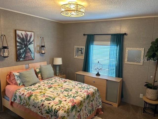 bedroom featuring crown molding, carpet, and a textured ceiling