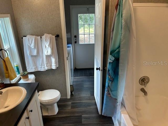 full bathroom featuring shower / tub combo, hardwood / wood-style flooring, vanity, and toilet