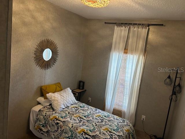 bedroom featuring a textured ceiling