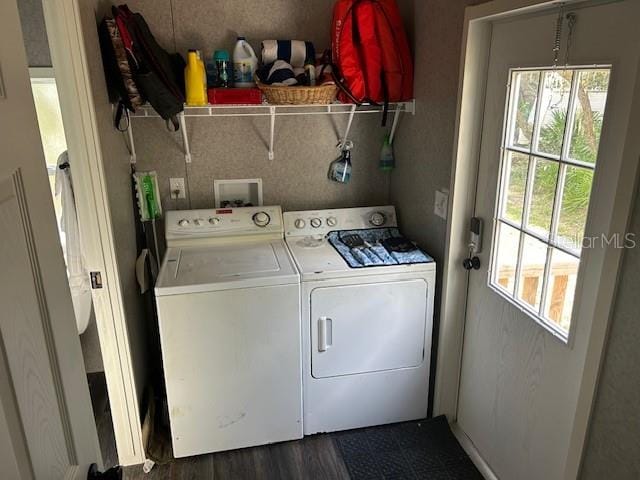 washroom featuring plenty of natural light, washing machine and dryer, and dark hardwood / wood-style floors