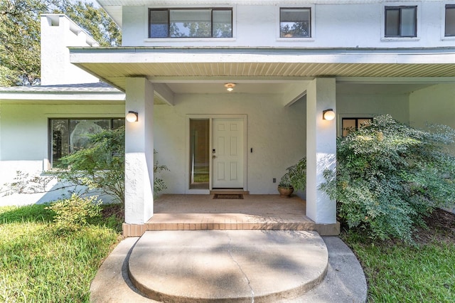 view of exterior entry with a porch