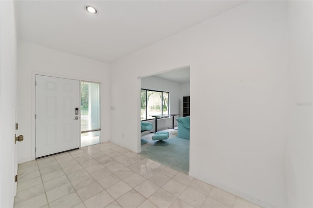 entrance foyer featuring light colored carpet