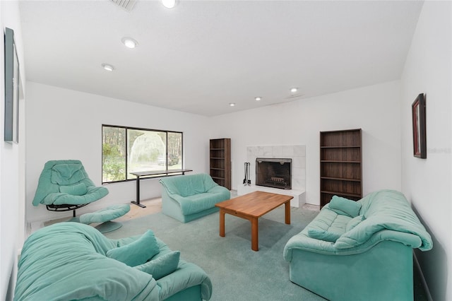 carpeted living room with a fireplace