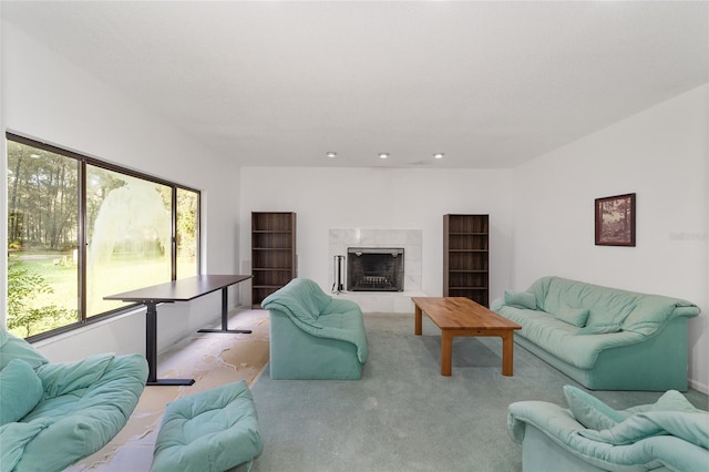 carpeted living room with a tile fireplace