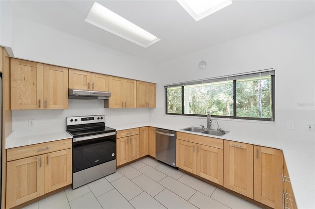 kitchen featuring light brown cabinetry, sink, light tile patterned floors, and stainless steel appliances