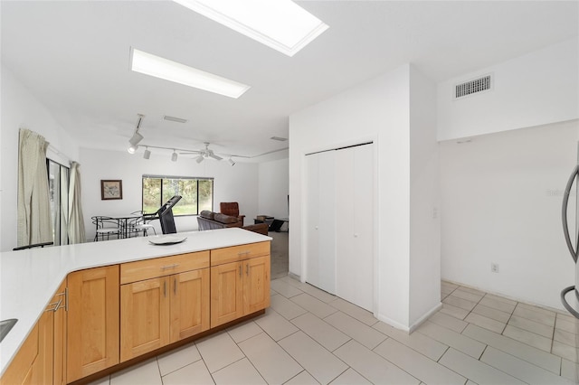 kitchen with ceiling fan and refrigerator