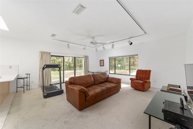 living room featuring ceiling fan, light carpet, and track lighting