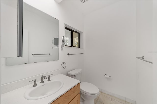 bathroom with vanity, toilet, and tile patterned floors