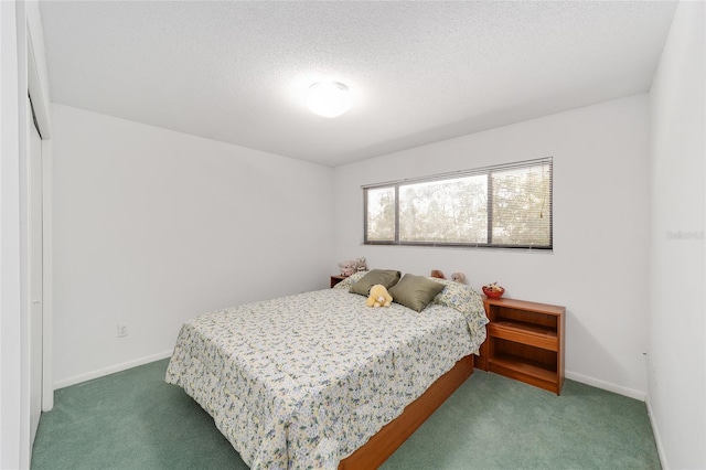 carpeted bedroom featuring a textured ceiling