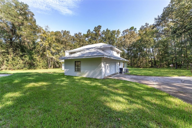 view of property exterior featuring a garage and a yard