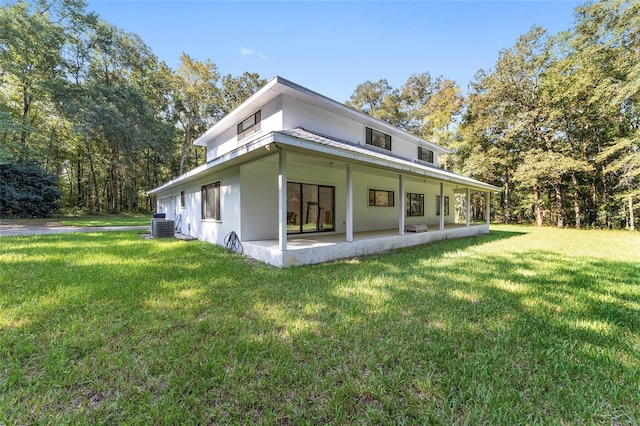 view of side of home featuring a yard and central AC