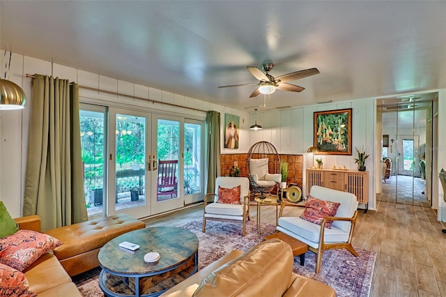 living room with french doors, light hardwood / wood-style flooring, and ceiling fan