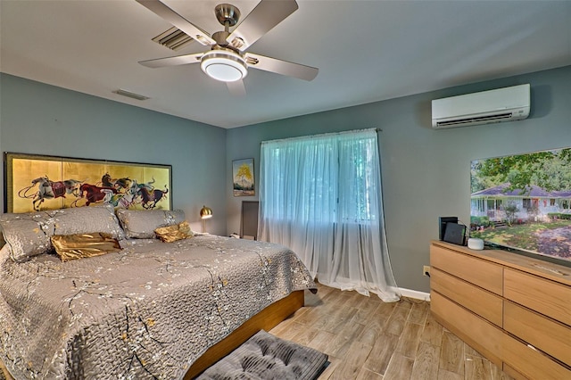 bedroom with light wood-type flooring, multiple windows, ceiling fan, and a wall mounted air conditioner