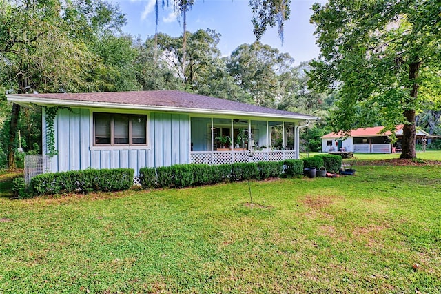 ranch-style home with covered porch and a front yard