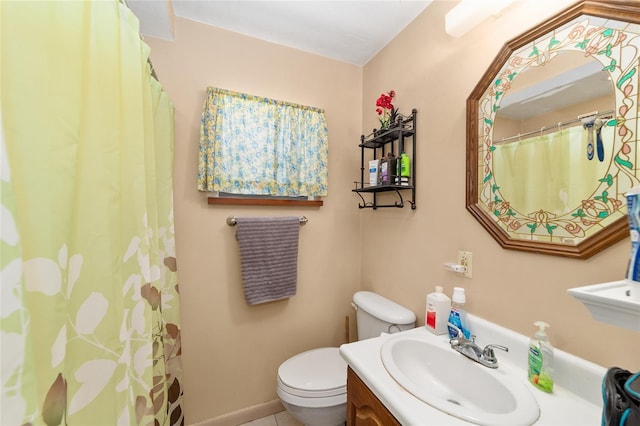 bathroom with tile patterned flooring, vanity, and toilet