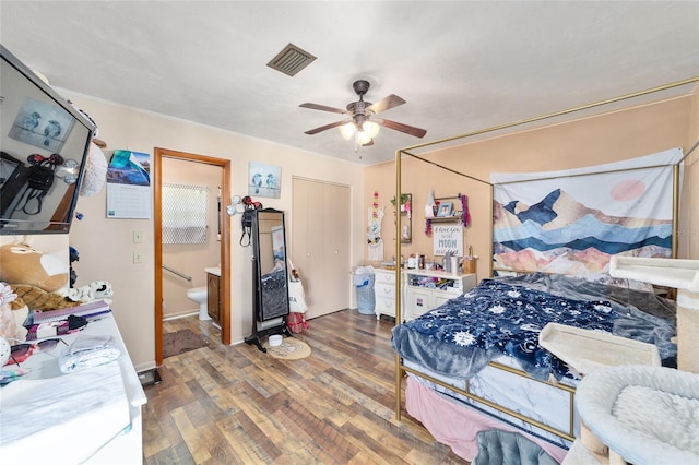 bedroom featuring ensuite bath, ceiling fan, and hardwood / wood-style floors