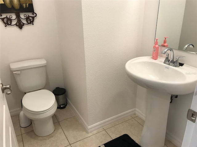 bathroom with toilet and tile patterned floors