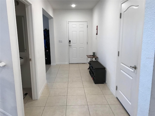 hall with light tile patterned flooring