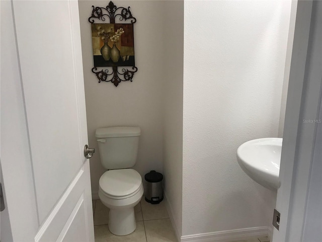 bathroom featuring tile patterned flooring and toilet