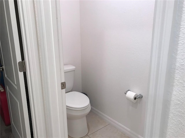 bathroom with tile patterned flooring and toilet