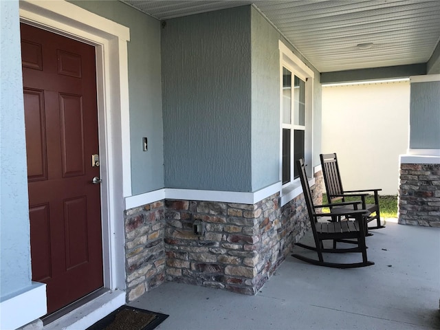 doorway to property featuring covered porch