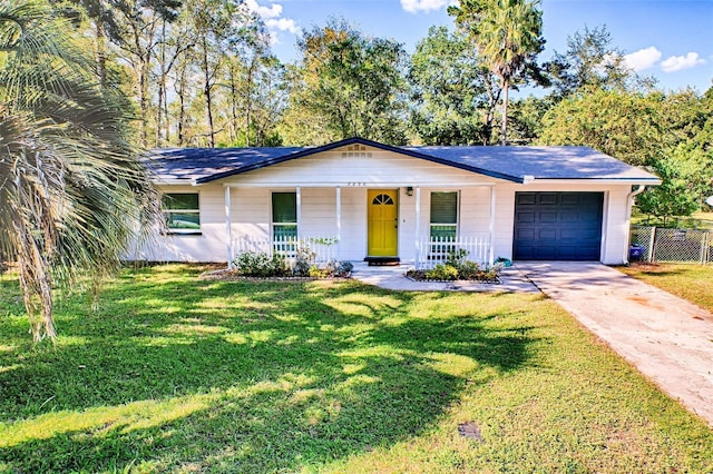 ranch-style house with a garage, a front lawn, and a porch