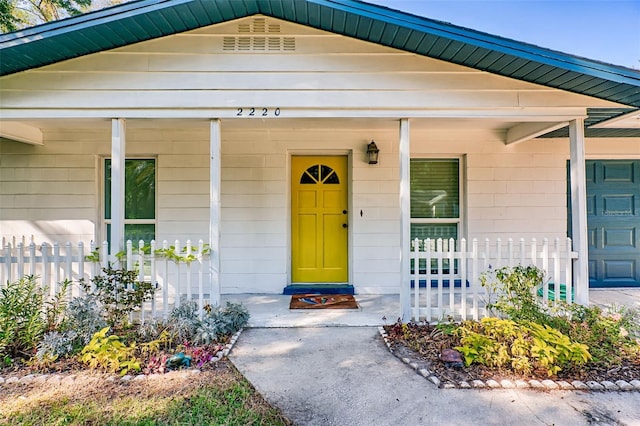 view of exterior entry with a porch