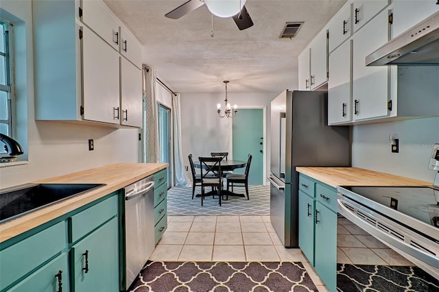 kitchen with ceiling fan with notable chandelier, decorative light fixtures, white cabinets, and electric range