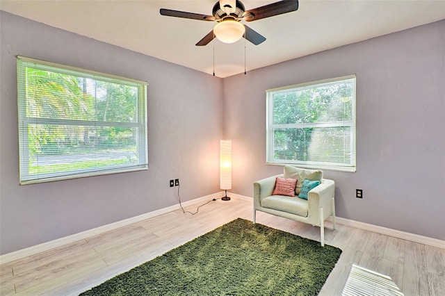 sitting room featuring light hardwood / wood-style floors and ceiling fan