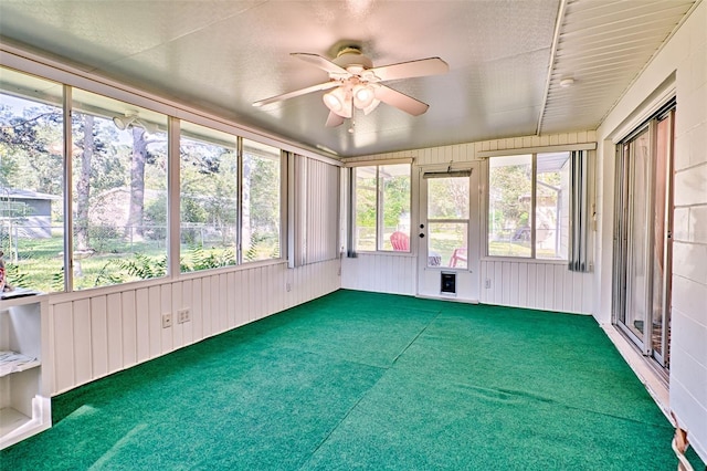 unfurnished sunroom with ceiling fan and a healthy amount of sunlight