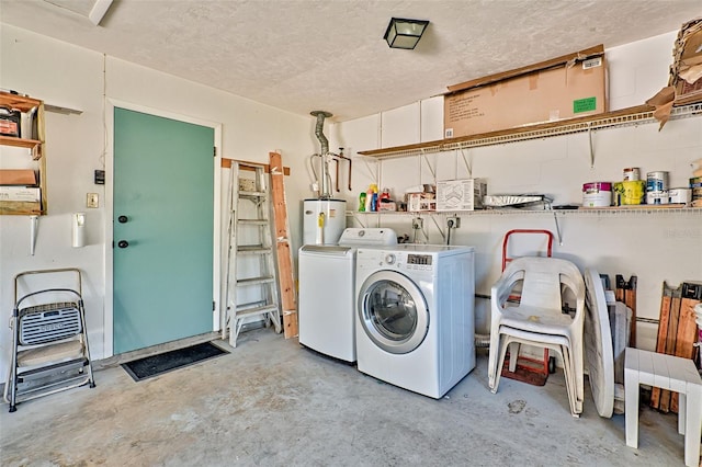 washroom with gas water heater, washer and dryer, and a textured ceiling