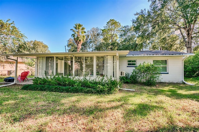 view of front facade with a front lawn and a sunroom