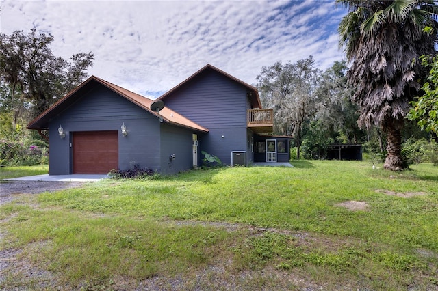 view of side of property with a garage and a lawn