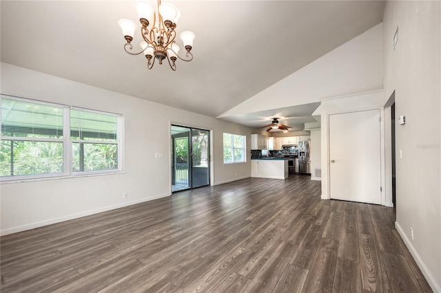 unfurnished living room featuring ceiling fan with notable chandelier, high vaulted ceiling, and dark hardwood / wood-style floors