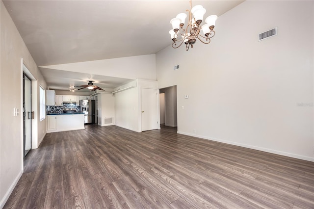 unfurnished living room with ceiling fan with notable chandelier, hardwood / wood-style floors, and high vaulted ceiling