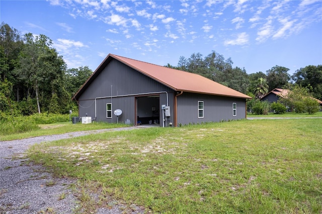 view of property exterior featuring a yard and an outdoor structure