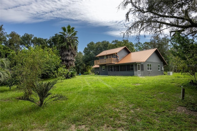 131 Riley Lake Dr, Hawthorne, FL 32640 - back of house with a sunroom, metal roof, and a yard