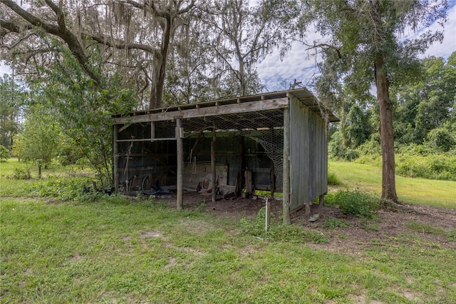 view of outbuilding featuring a yard