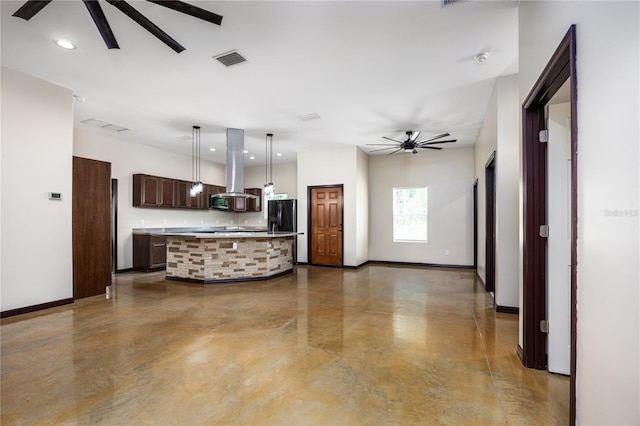 kitchen featuring a center island, island range hood, decorative light fixtures, concrete flooring, and ceiling fan