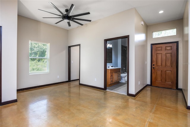 entryway featuring ceiling fan, sink, and concrete floors