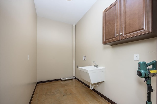 laundry room featuring cabinets, washer hookup, and sink