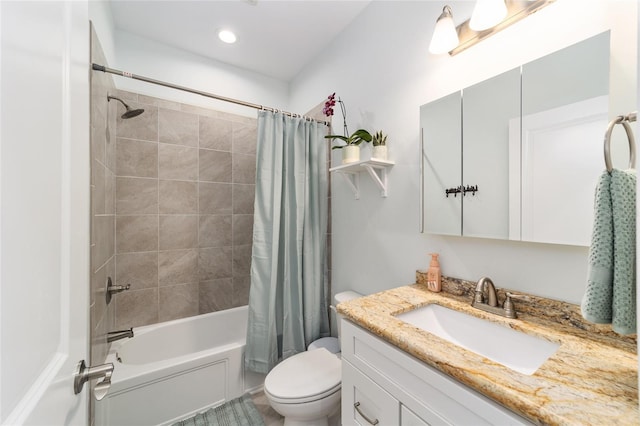 full bathroom with vanity, shower / bath combo with shower curtain, and toilet