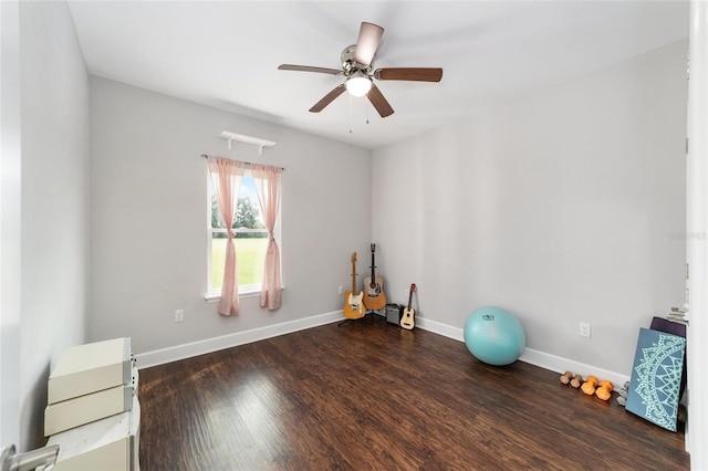 workout area with ceiling fan and dark hardwood / wood-style flooring