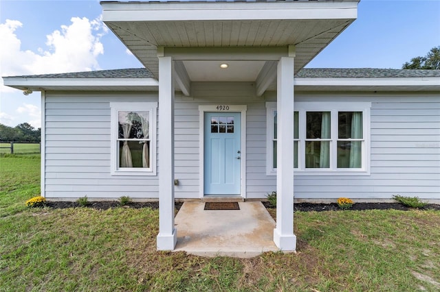 entrance to property featuring a yard