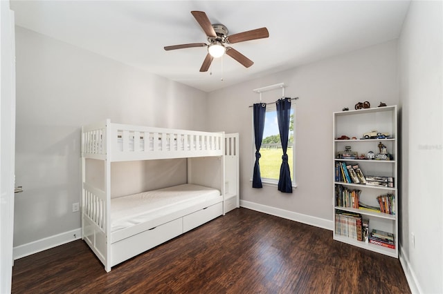 unfurnished bedroom featuring ceiling fan and dark wood-type flooring